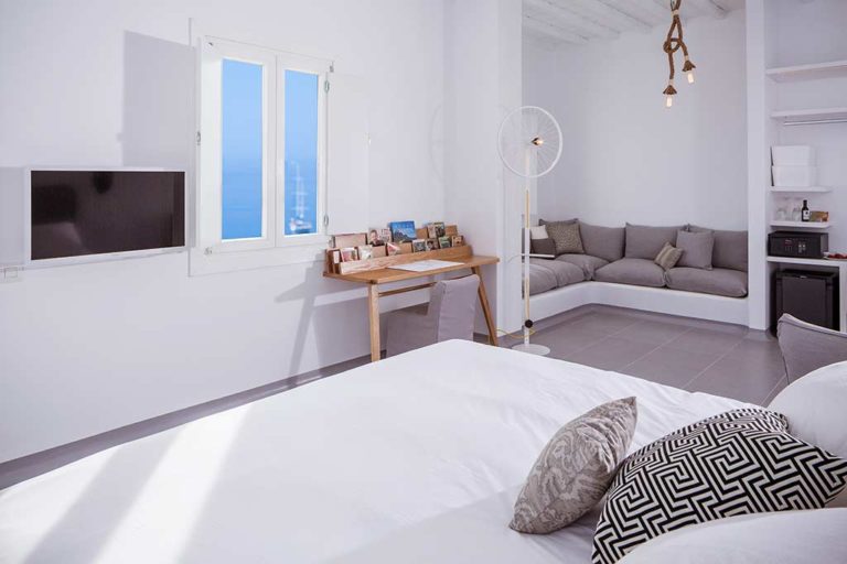 Boheme Mykonos - Superior Sea View Suite bed, sitting area, and workstation