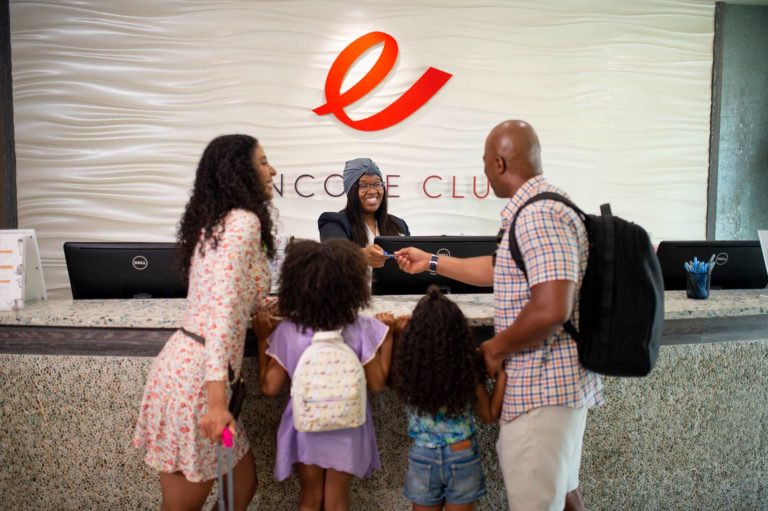 Family at front desk checking into Encore Resort