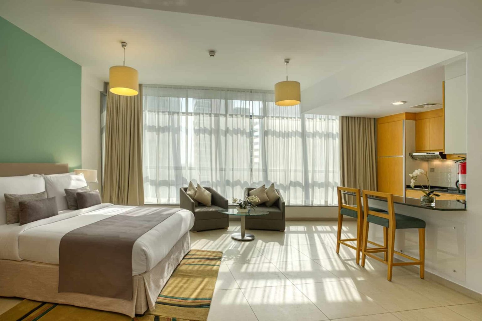 Grand Heights Hotel Apartments deluxe studio suite with bed and kitchenette