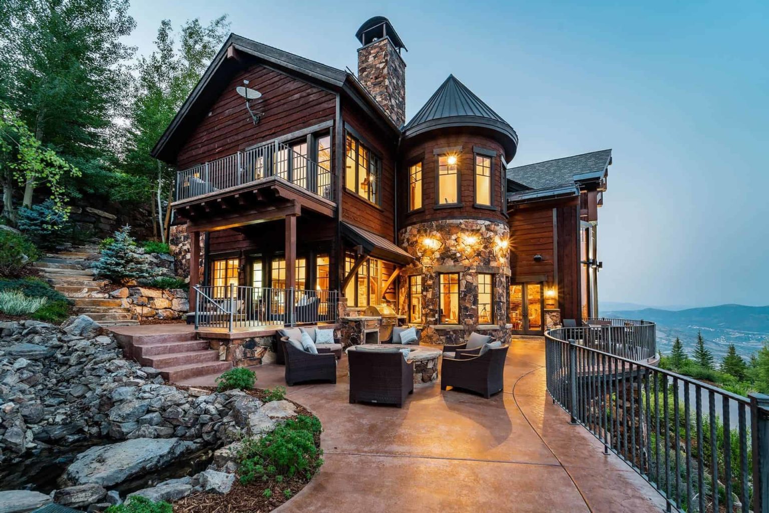 Black Spruce Home exterior with outdoor porch overlooking mountains: Luxury Homes by Stein Collection
