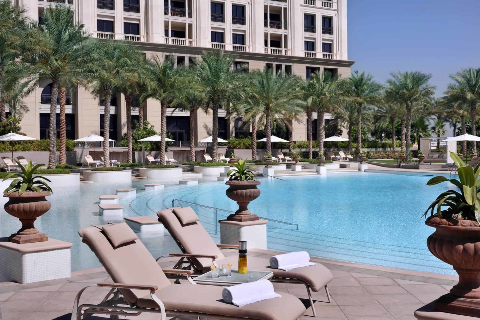 Sun loungers by the pool at Palazzo Versace Dubai Hotel