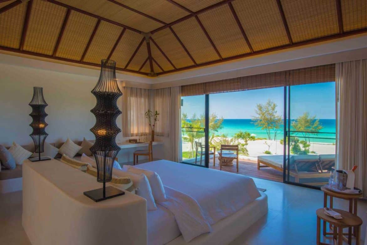 Three Bedroom Villa bedroom with king bed and sitting area at the Royal Sands Koh Rong
