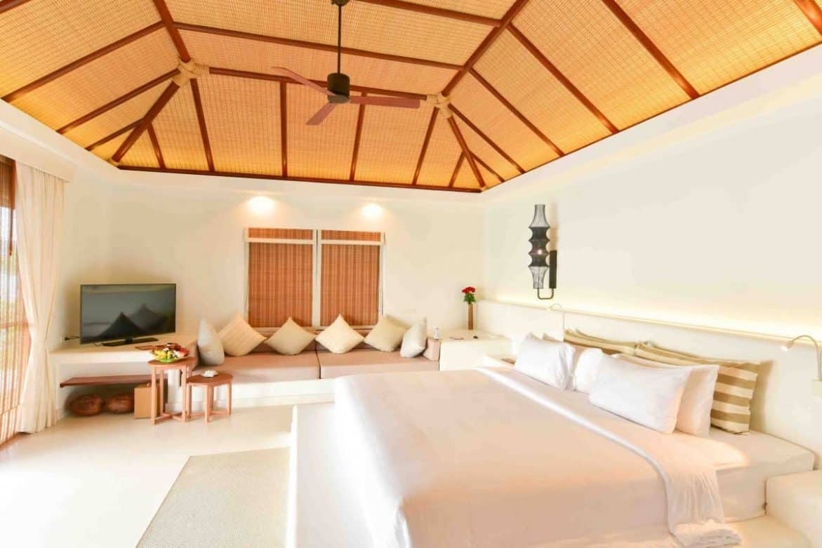 Beachfront Pool Villa bedroom with king size bed and sitting area at the Royal Sands Koh Rong