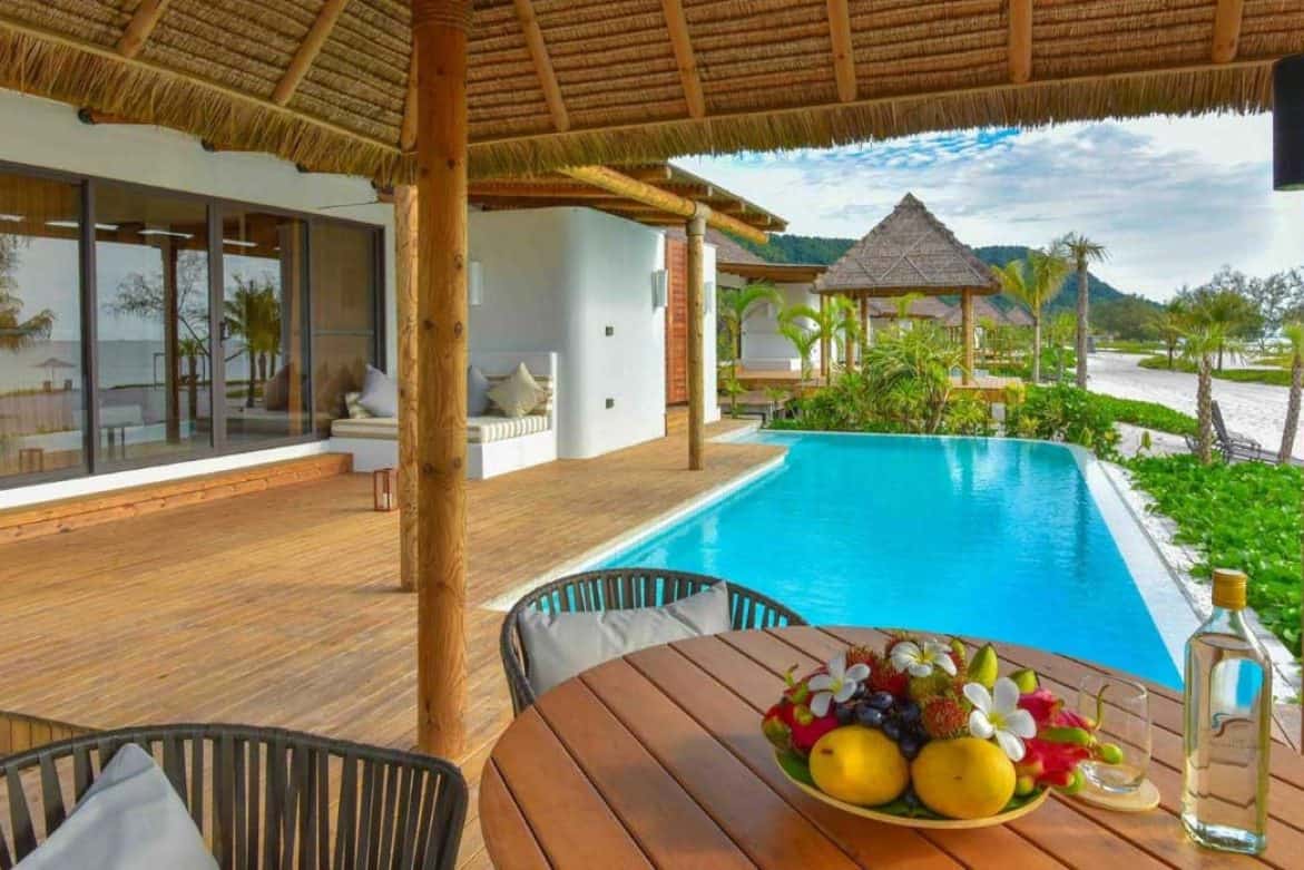 Terrace with dining area, daybed, and pool of the private Beachfront Pool Villa at the Royal Sands Koh Rong
