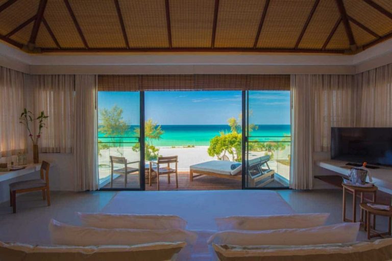 Beachfront Villa bedroom with views of outdoor terrace and ocean at the Royal Sands Koh Rong