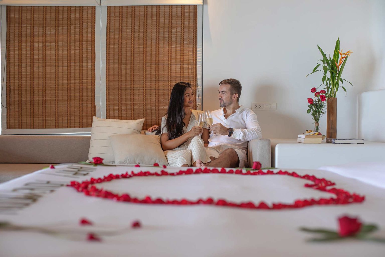 Couple toasting champagne glasses in their Royal Sands Koh Rong villa