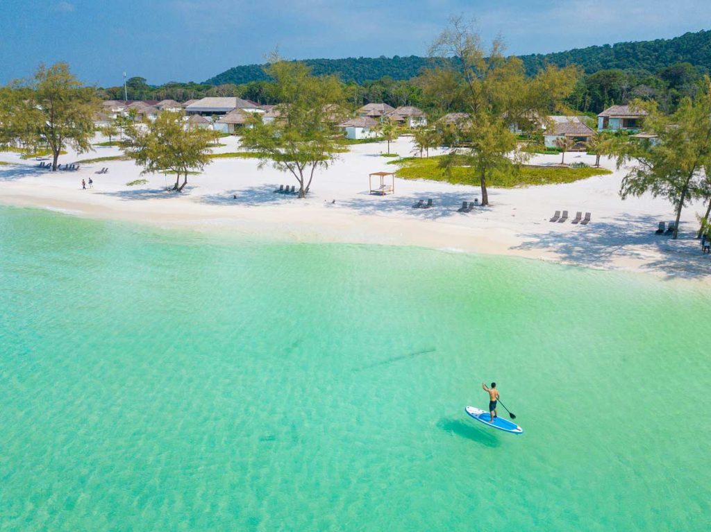 Man paddleboarding on the ocean at the Royal Sands Koh Rong