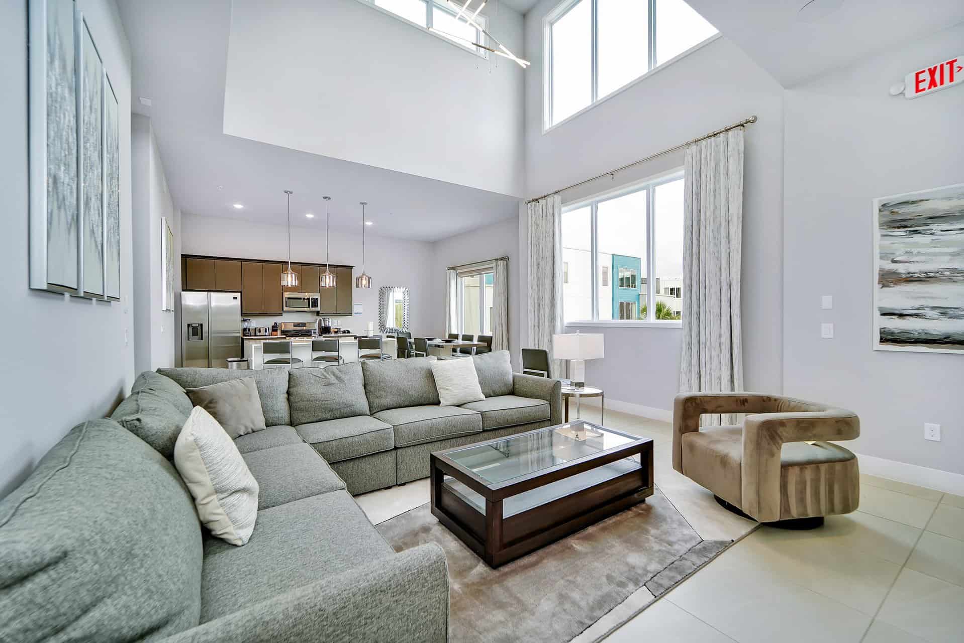 Specious living room and full kitchen with high ceilings and windows at Spectrum Resort Orlando