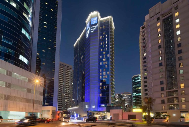 TRYP by Wyndham Dubai hotel tower exterior at night
