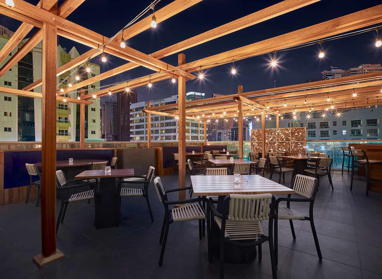 Blacksmith Restaurant outdoor dining area at night at Wyndham Dubai Marina Hotel