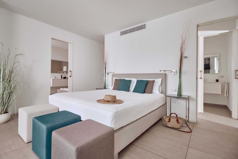 Divinity Breeze suite bedroom with double bed and en-suite bathroom | Baobab Suites