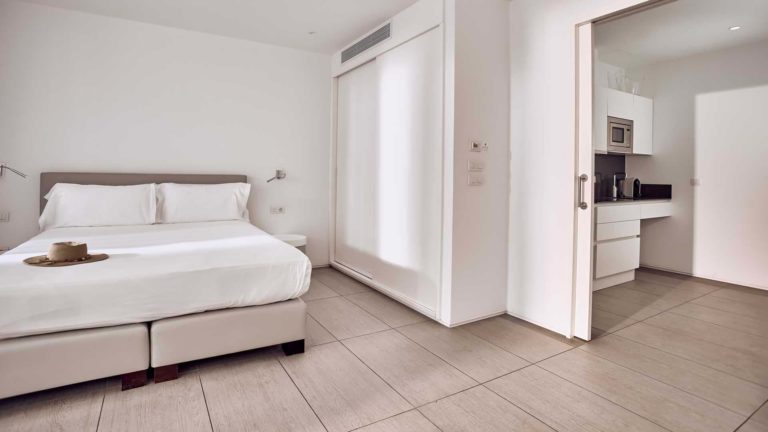 Divinity Studio suite bedroom with sliding door to kitchen | Baobab Suites