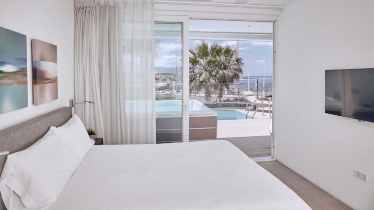 Dormitorio en suite Infinity Mar con puertas correderas que dan a la terraza | Suites Baobab
