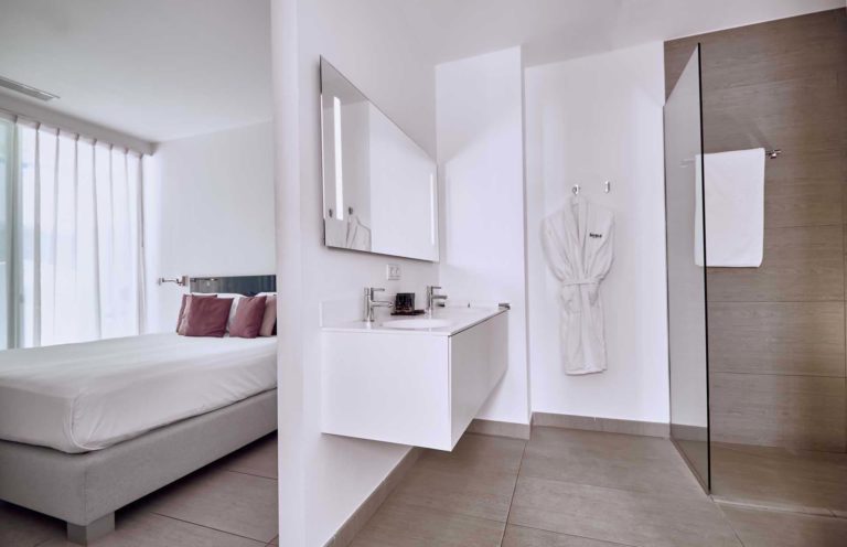 Serenity Pico suite bedroom and en-suite bathroom with walk-in shower| Baobab Suites
