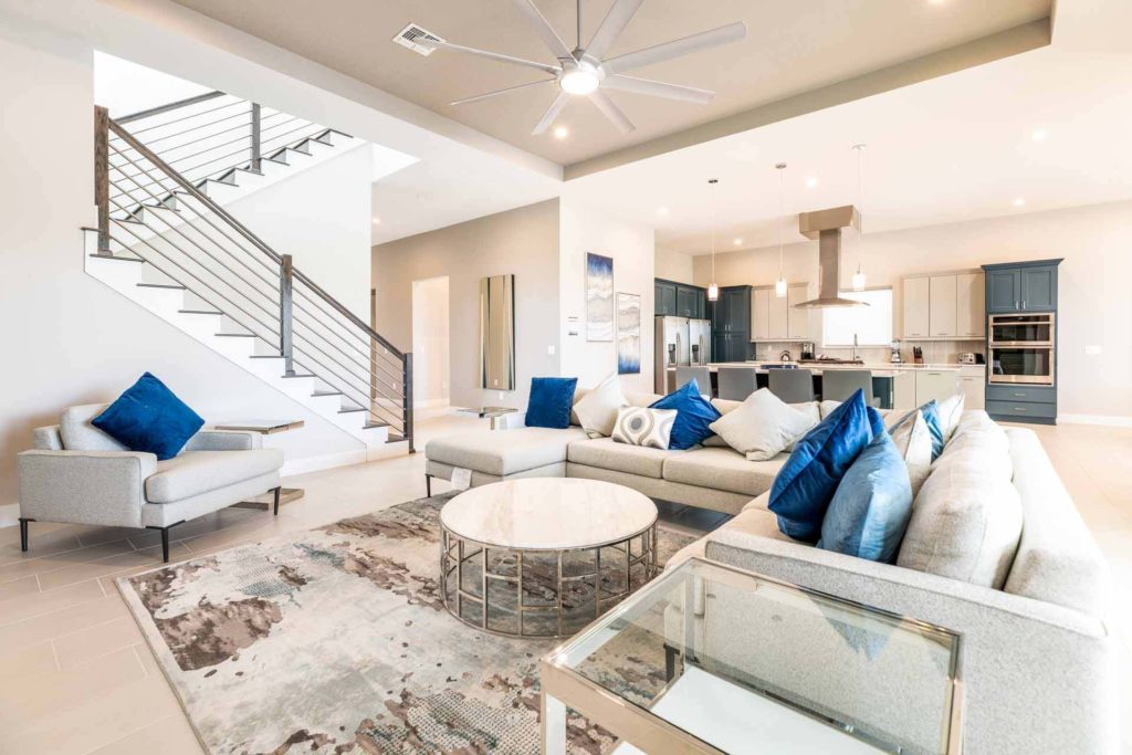 Open concept living room and kitchen with contemporary furnishings at the Bear's Den Resort Orlando
