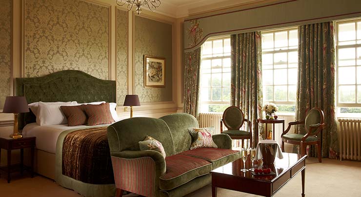 Feature Suite king bed and sitting area at Brockencote Hall