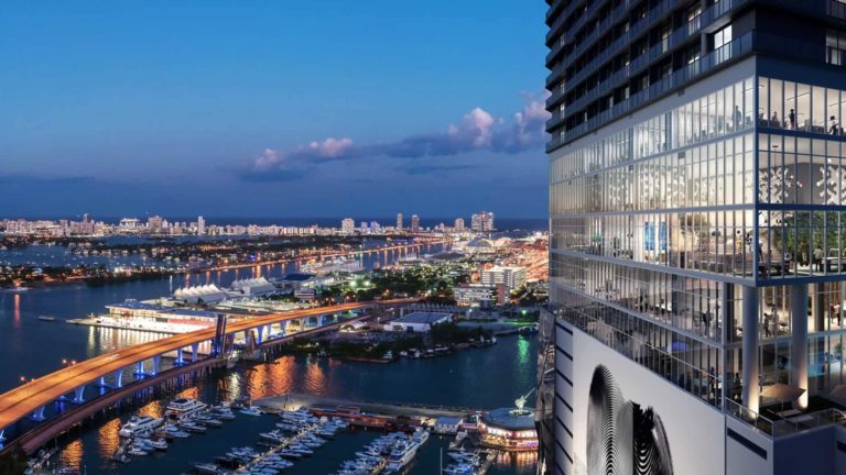 The Elser Hotel and Residences Miami tower overlooking Biscayne Bay marina at night