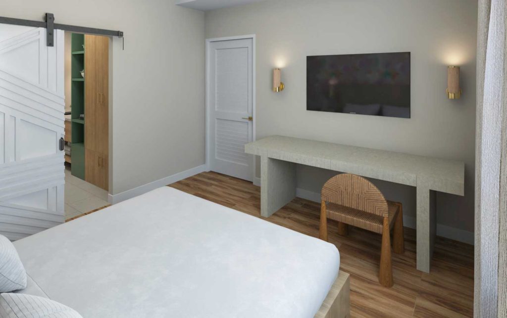 Suite bedroom with desk and wall-mounted TV at Embassy Suites by Hilton Orlando Sunset Walk