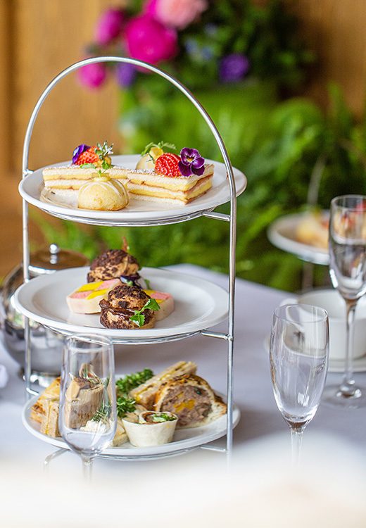 Tiered serving tray with sandwiches, biscuits, and desserts for Afternoon Tea at the Greenway Hotel