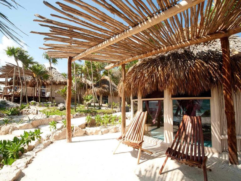 Cabaña with ocean view - covered outdoor patio with sitting area at the Papaya Playa Project