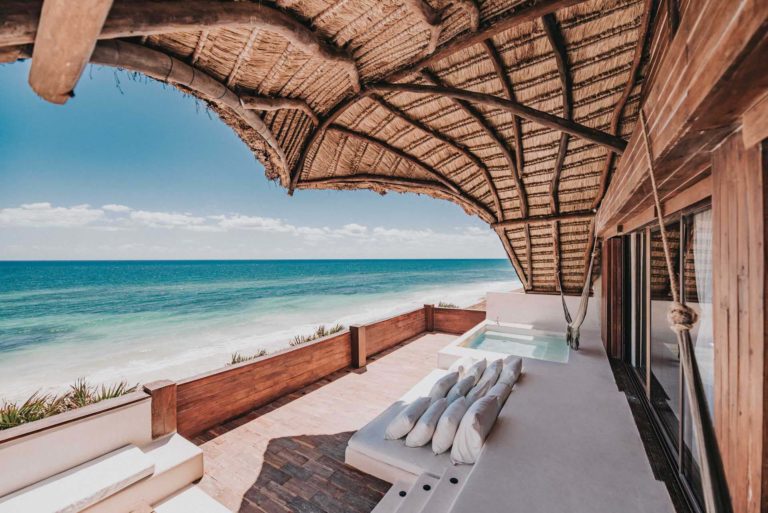 Casa Palapa: terraza cubierta al aire libre con área de descanso y vista al mar en el Proyecto Papaya Playa