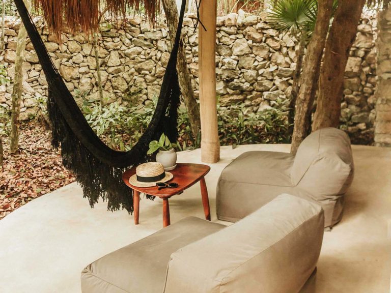 Casita jungle view with rooftop pool - covered patio with lounge chairs and hammock at the Papaya Playa Project