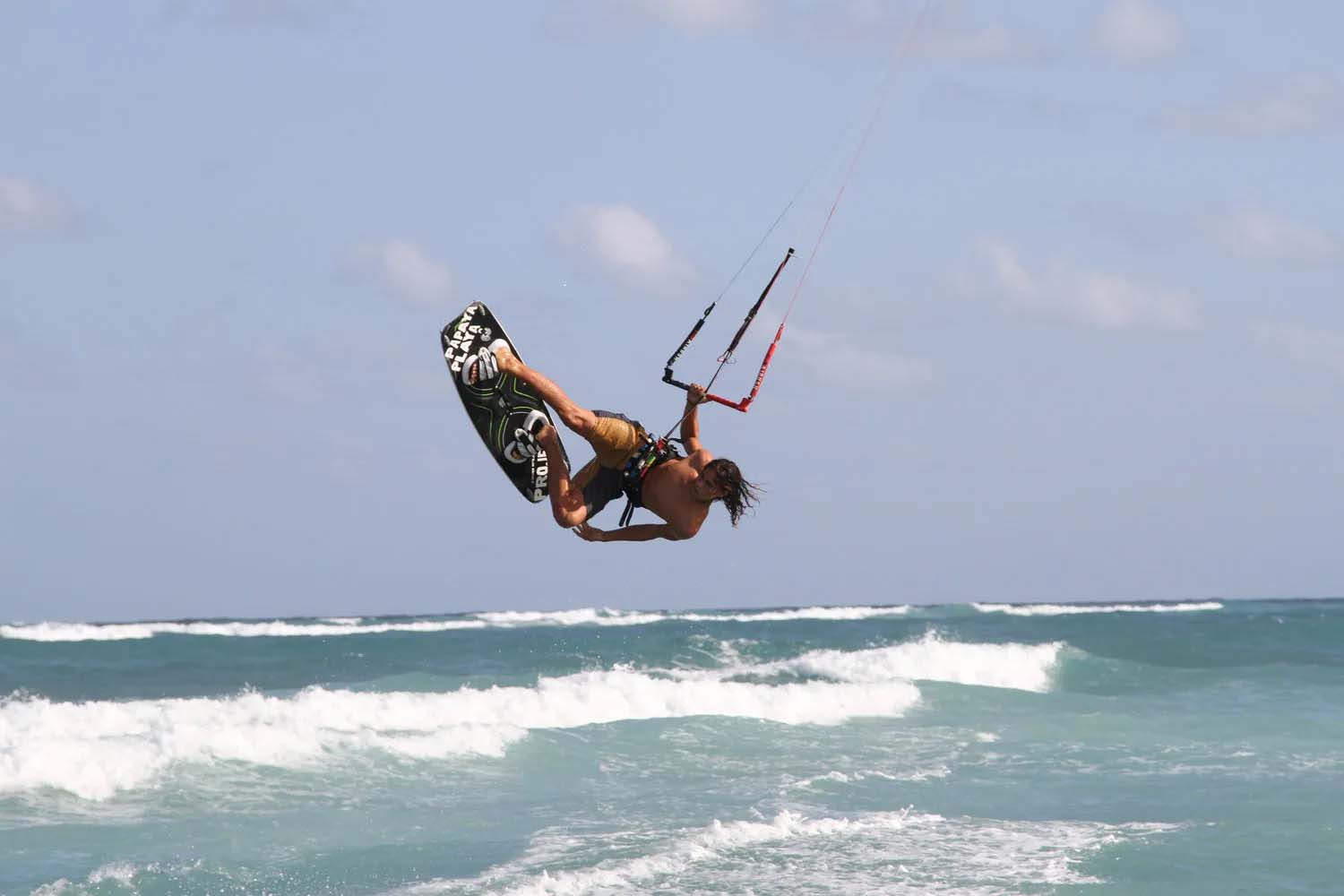 Man kite surfing on the ocean at the Papaya Playa Project