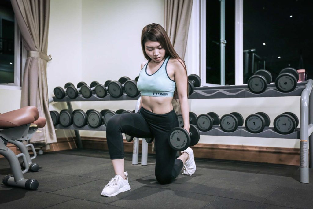 Woman lifting weights at the Sokha Siem Reap Resort fitness center