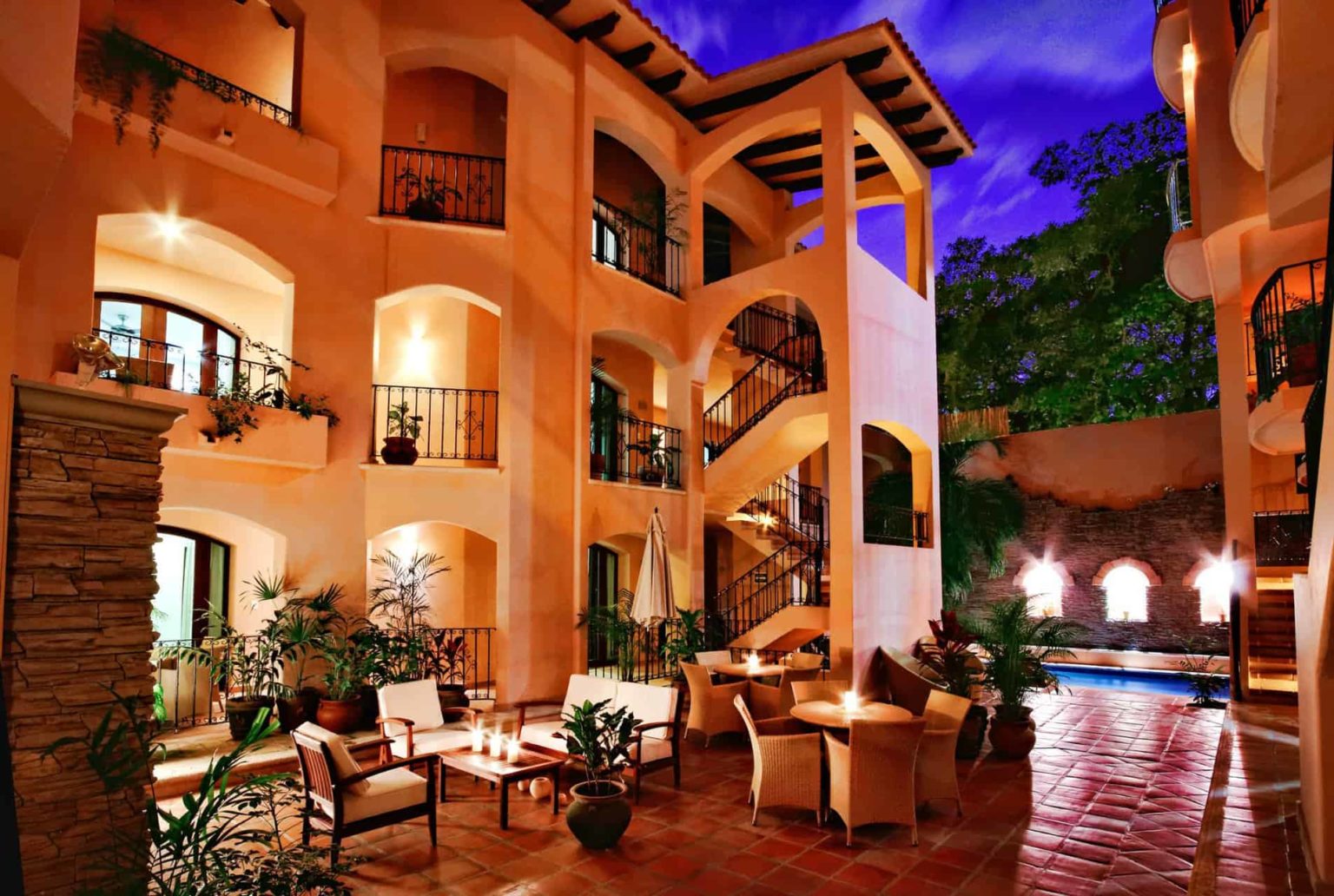 Acanto Hotel Playa del Carmen outdoor patio and pool at night