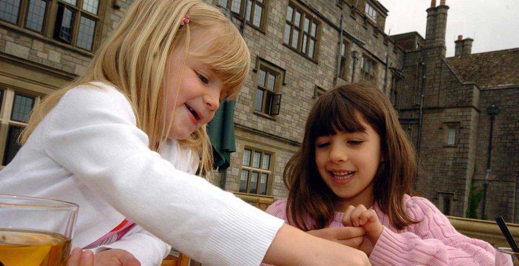 Young girls doing a brass rubbing activity at Bovey Castle