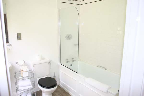 Mews Room - Bathroom with shower and tub combination and a toilet | Bovey Castle