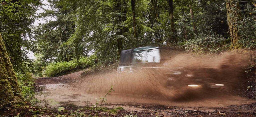 Jeep driving through mud in a forest near Bovey Castle