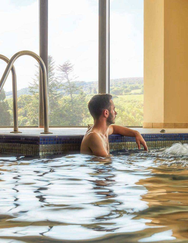 Man sitting in the pool at the Bovey Castle Spa
