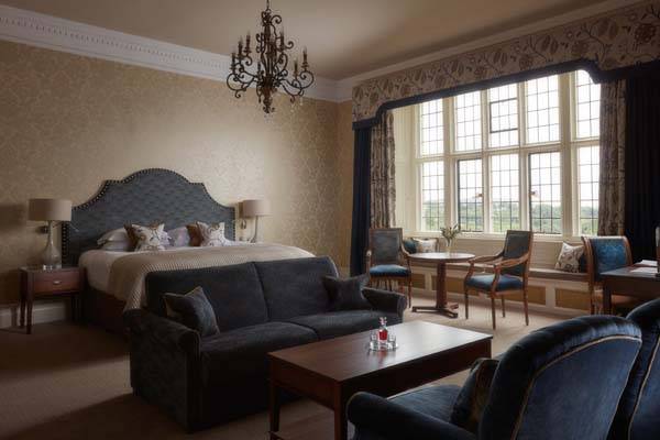 State Room - Bedroom with king bed, sitting area, and workstation | Bovey Castle
