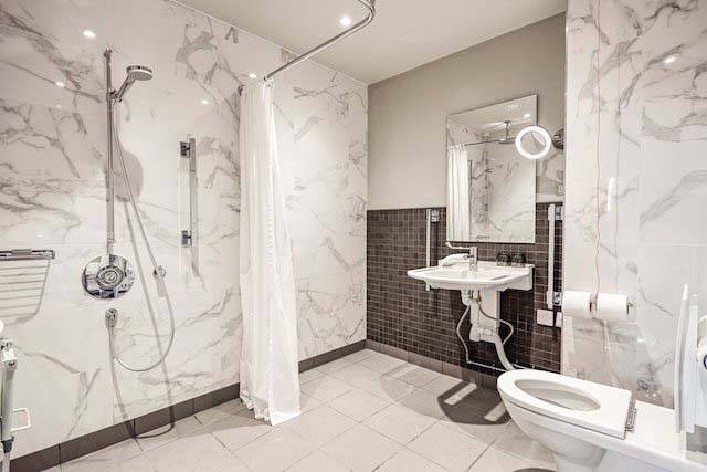 Accessible Superior Deluxe Room - Accessible bathroom with shower, toilet, and sink | Mallory Court