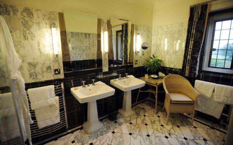 Manor House Master Room - Bathroom with double sinks, makeup table and chair | Mallory Court