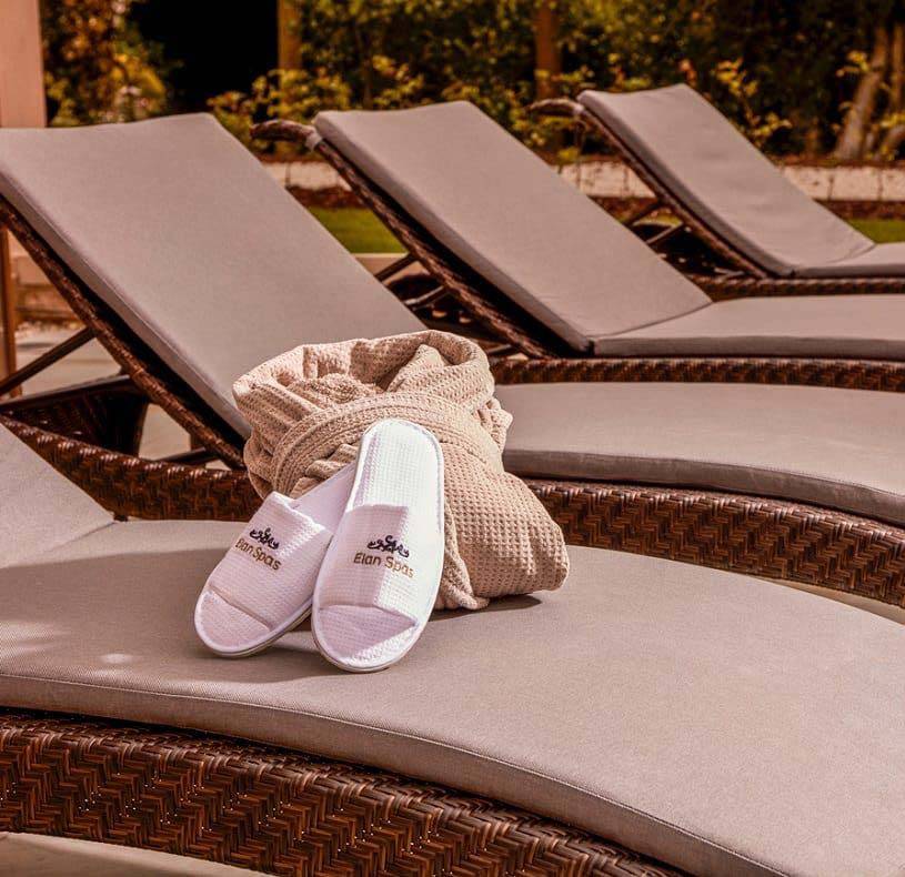 Slippers and robe set on a lounge chair at the Mallory Court Spa