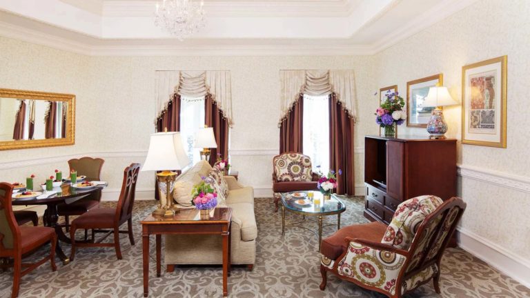 Chateau Club King Suite - European inspired decor with sitting area, dining table, workstation, and entertainment center | Nemacolin