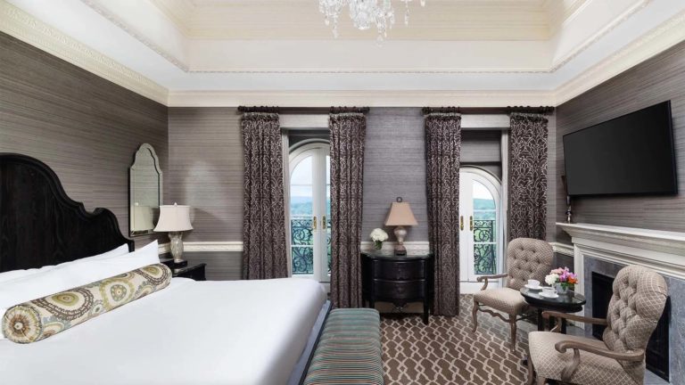Chateau Presidential Suite - European inspired bedroom with king bed and sitting area | Nemacolin