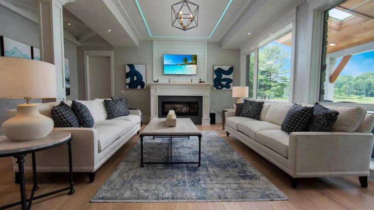 The Estates Mallard's Landing - Living room with comfy seating and TV above fireplace | Nemacolin