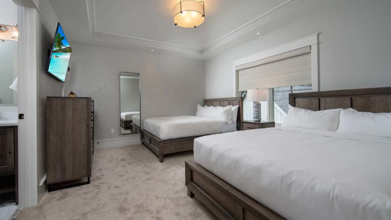The Estates Mallard's Landing - Bedroom with 2 queen beds, TV, and en-suite bathroom | Nemacolin