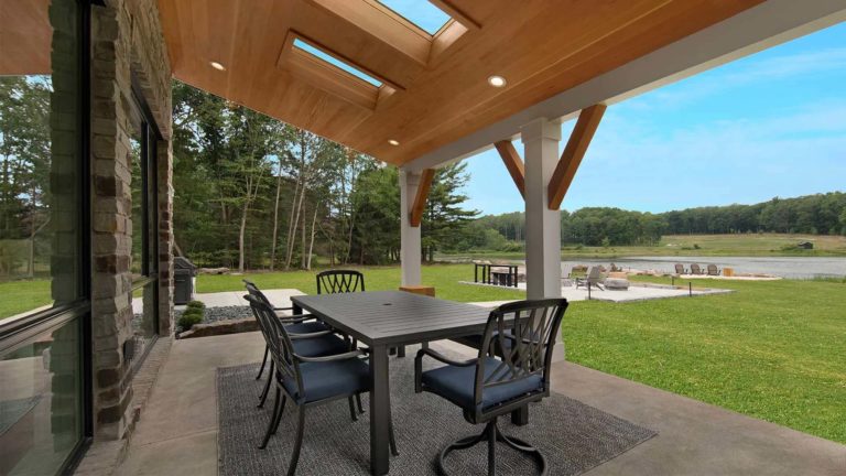 The Estates Mallard's Landing - Covered outdoor patio with dining table and chairs | Nemacolin