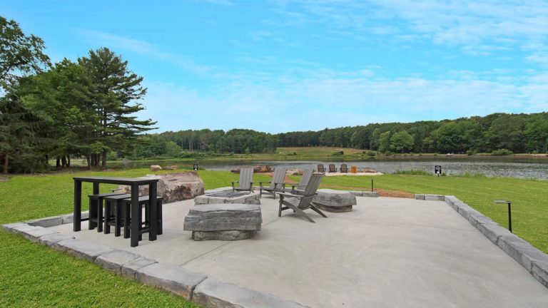 The Estates Mallard's Landing - Outdoor patio with adirondack chairs and fire pit | Nemacolin