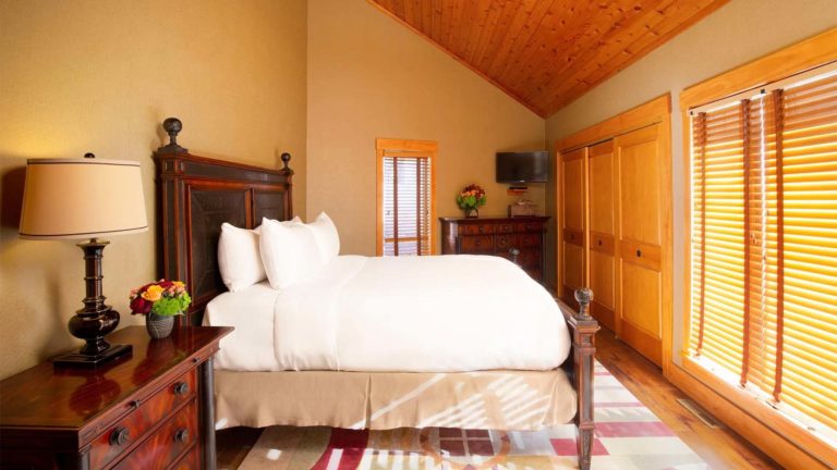 The Homes Deer Path Lodge - Rustic bedroom with king bed, TV, and closet | Nemacolin