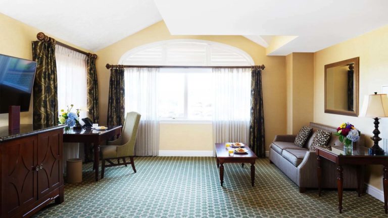 Lodge Double Suite - resort room with living area, TV, and workstation | Nemacolin