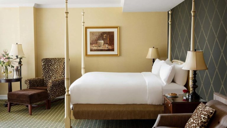 Lodge Family Suite - resort room with king bed and sitting area | Nemacolin