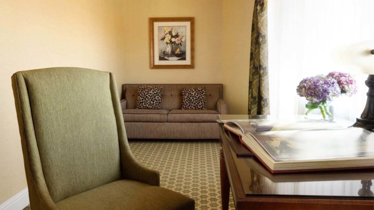 Lodge Family Suite - resort room with sitting area and workstation | Nemacolin