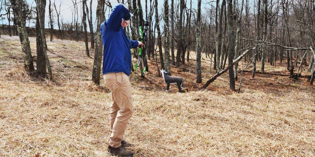 Man with bow and arrow practicing wilderness archery at the Nemacolin Field Club