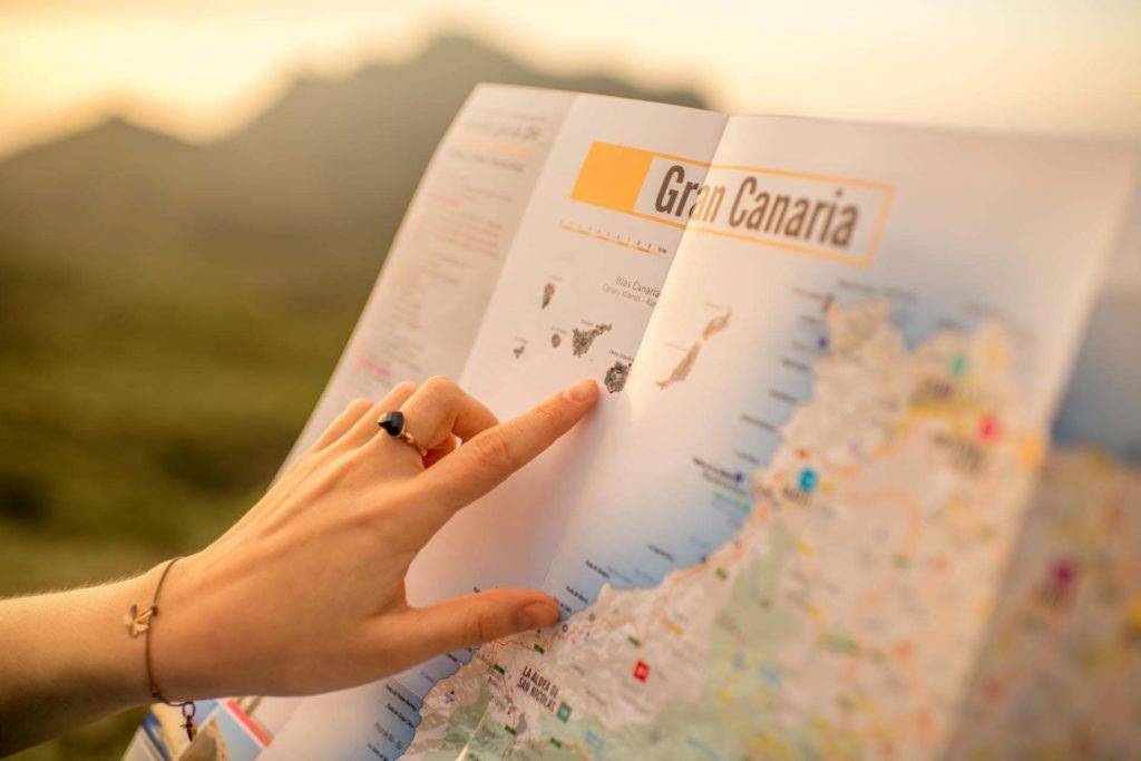 Frau, die eine Karte von Gran Canaria betrachtet