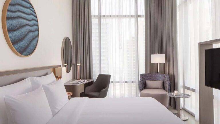 Classic Room - contemporary room with king bed, sitting area, workstation and large windows | First Collection Hotel at JVC